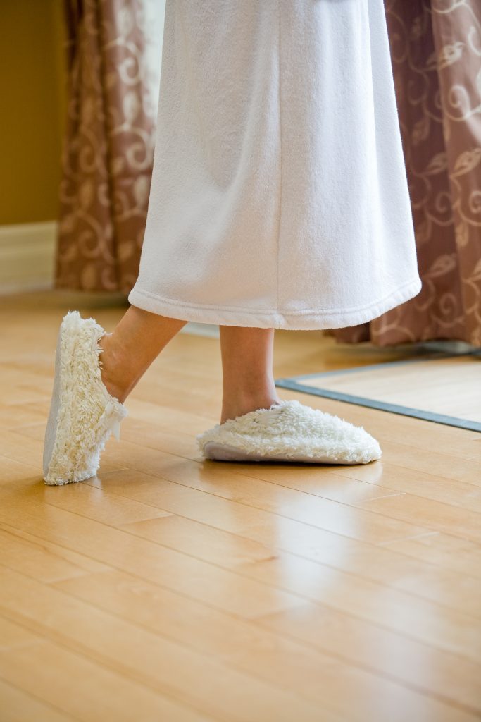 legs of woman in robe and slippers